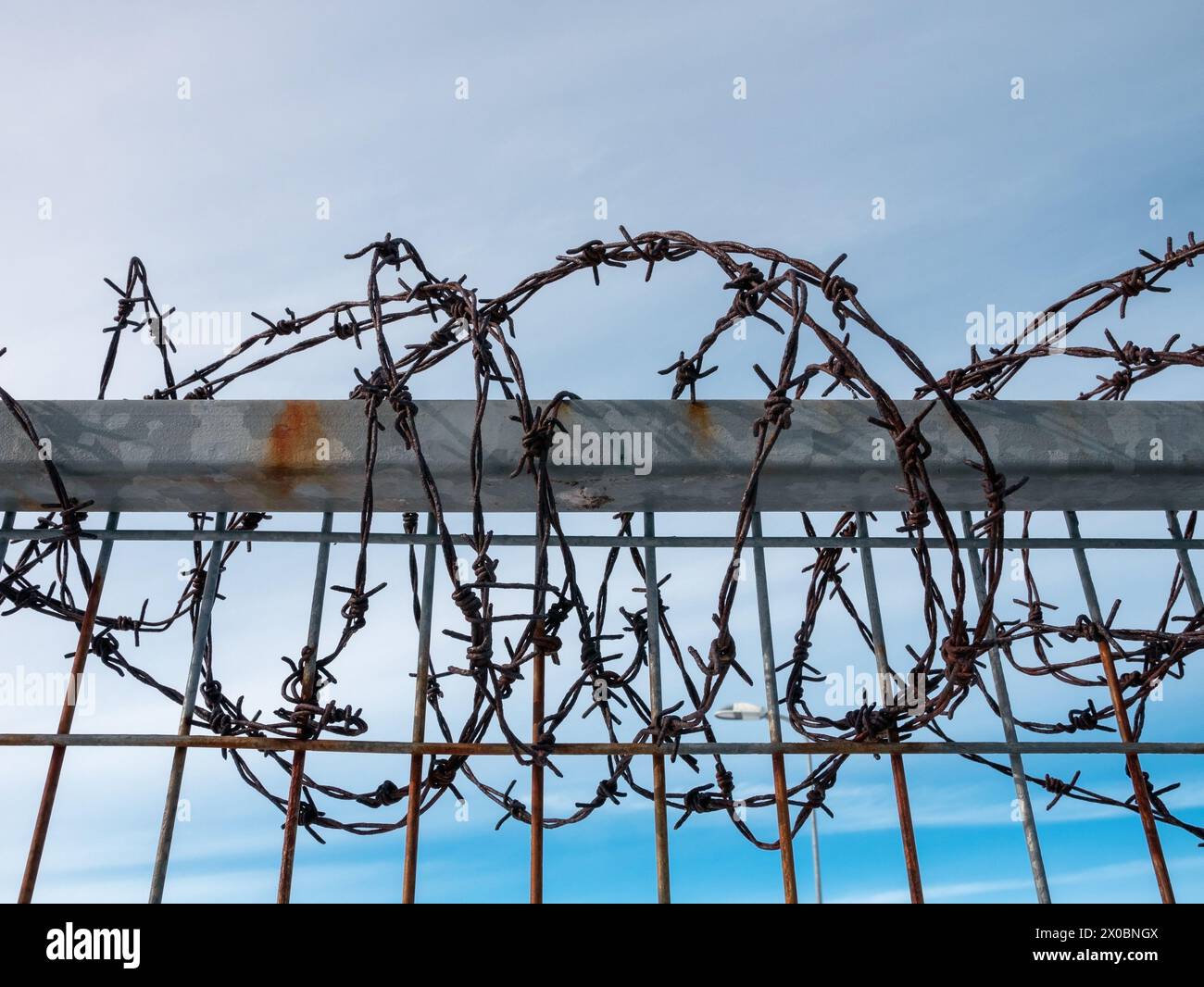 rusty old barbed wire on fence Stock Photo - Alamy
