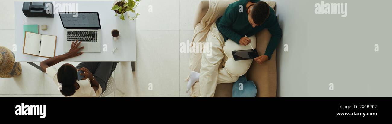 Header with young couple working from home Stock Photo