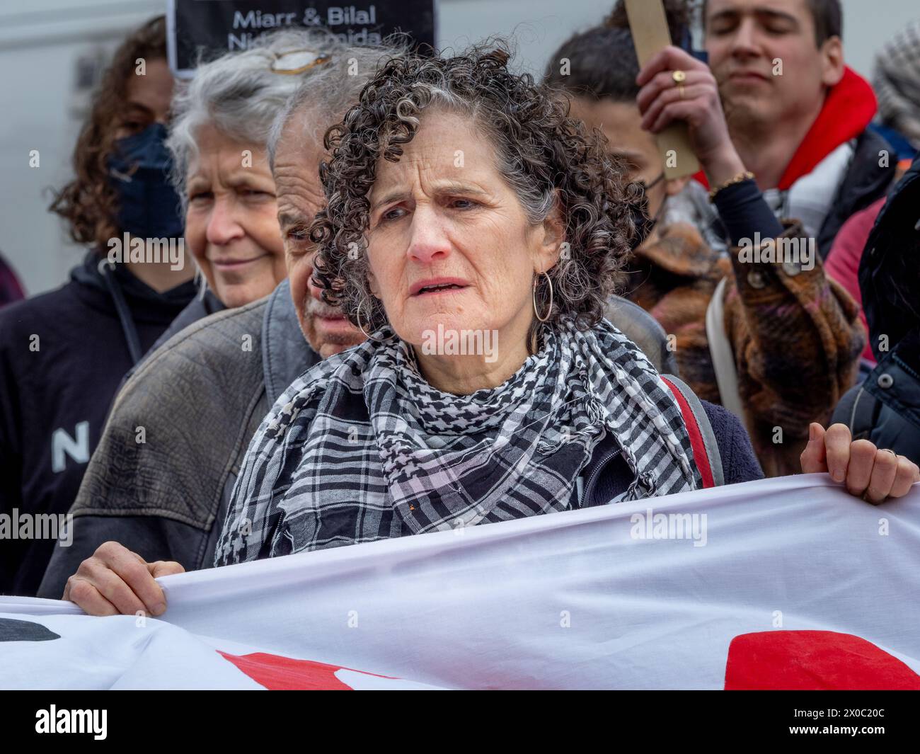 April 6, 2024, Brooklyn, United States: A protester gets emotional as a list of names of children, victims of the Israel-Gaza war is read during a Pro-Palestine demonstration. Protesters gather at Grand Army Plaza in Brooklyn to protest the killing of children in Gaza. They joined the Jewish Elders & Friends for Ceasefire, a part of Jewish Voice for Peace. The focus was on urging Senator Schumer to cease arming genocide with the tagline ''We demand action, not empty words.'' The route went through the farmerâ€™s market to highlight the famine's impact on Palestinian children. Plans to march to Stock Photo