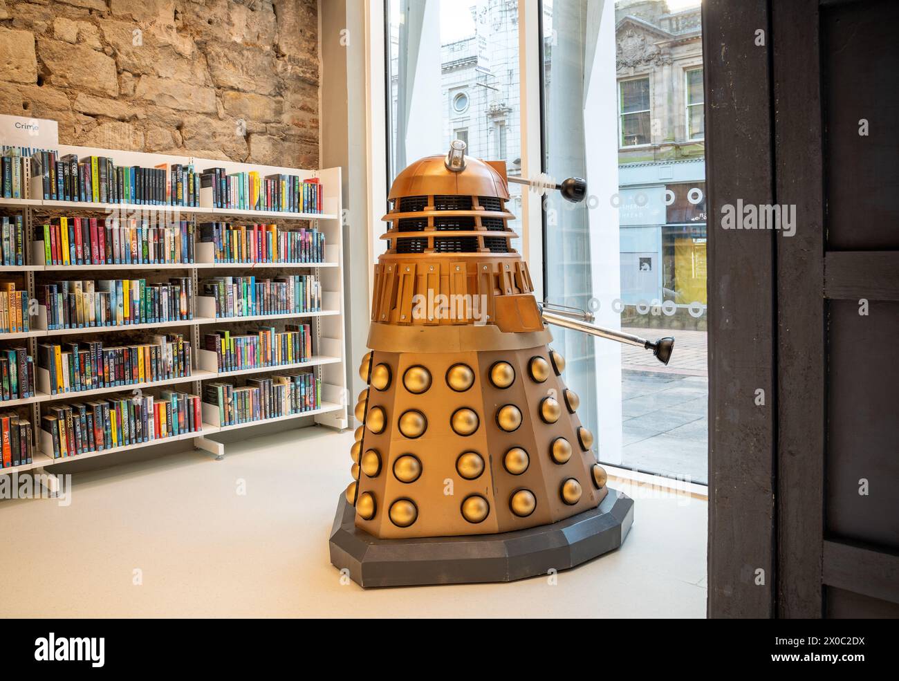 Book shelving and Dalek at the Paisley Central Library opened in 2023 on Paisley High Street Stock Photo