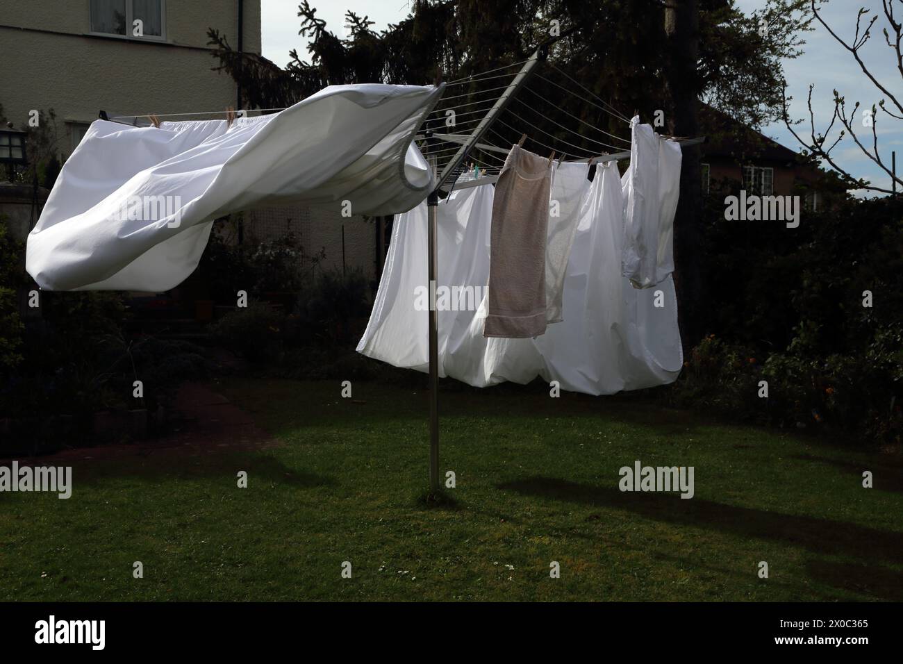 Laundry on Rotary Line Blowing in Gusty Winds of Storm Kathleen on 6th April 2024 Surrey England Stock Photo