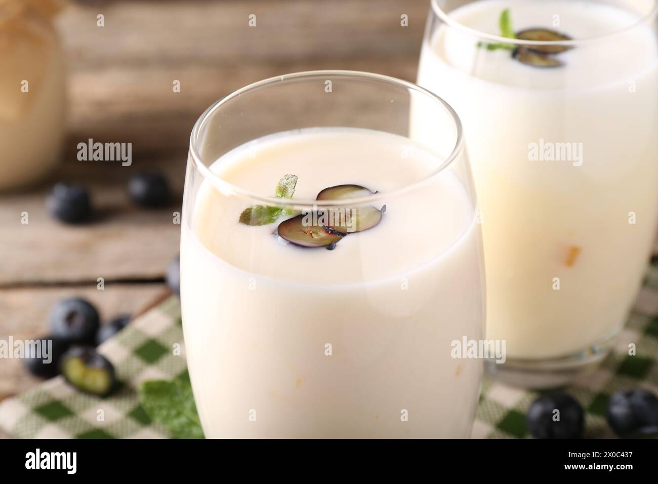 Tasty yogurt in glasses and blueberries on table, closeup Stock Photo