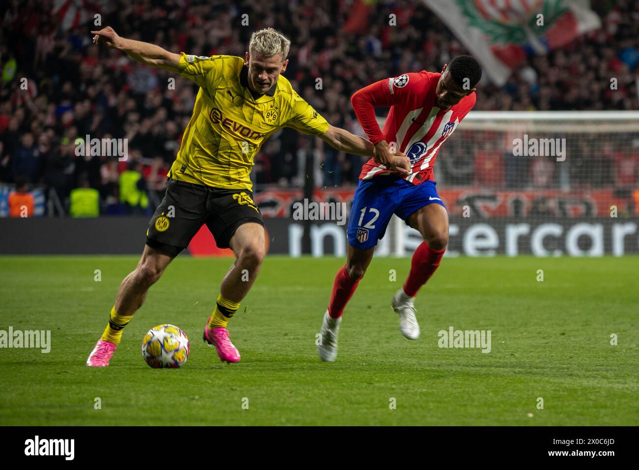 Borussia Dotmund player Julian Ryerson (L) struggles with Atletico de Madrid player Samuel Lino (R) during the UEFA Champions League quarterfinal match at the Metropolitan Stadium in Madrid. First leg match for the quarterfinals of the UEFA Champions League played at the Metropolitan Stadium in Madrid between Atlético de Madrid and the German Borusia Dormund with a score of 2 goals to 1 for the local team with goals from Rodrigo de Paul (4' ) and Samuel Lino (32') for the ATM and Sebastian Haller (81') for the visitors. (Photo by David Canales/SOPA Images/Sipa USA) Stock Photo