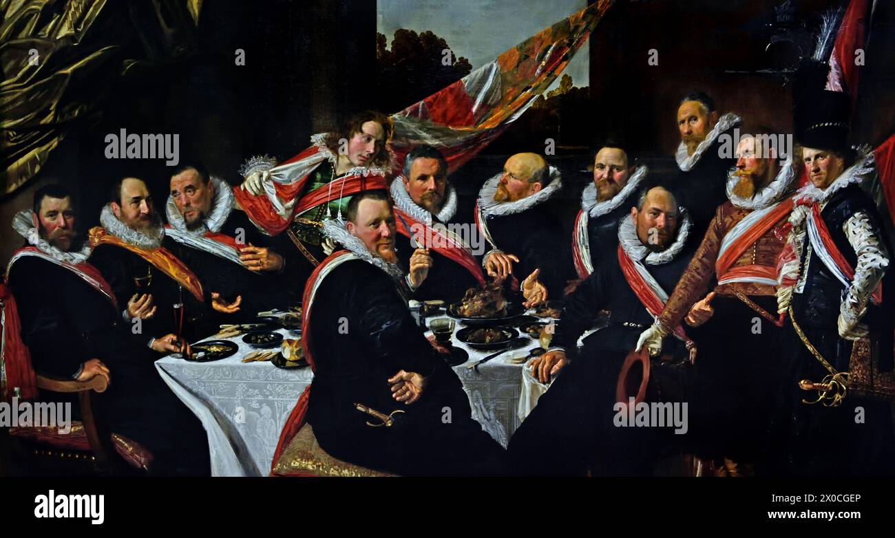 Banquet of the Officers of the St George Civic Guard 1616 by Frans Hals, 1582-1666, Antwerp- Haarlem,  Dutch, The Netherlands, 17th century, Dutch Golden Age (  St. George Civic Guard. They were a voluntary paramilitary force that both policed and protected the city of Haarlem in the Netherlands.  )  ( He painted lively, sometimes even cheerful, portraits of people from all levels of society,  important people, naughty children and even drunks or people who had been declared crazy. ) bANQUET OF THE oFFICERS OF THE ST gEORGE cIIVIC gUARD 1616 Stock Photo