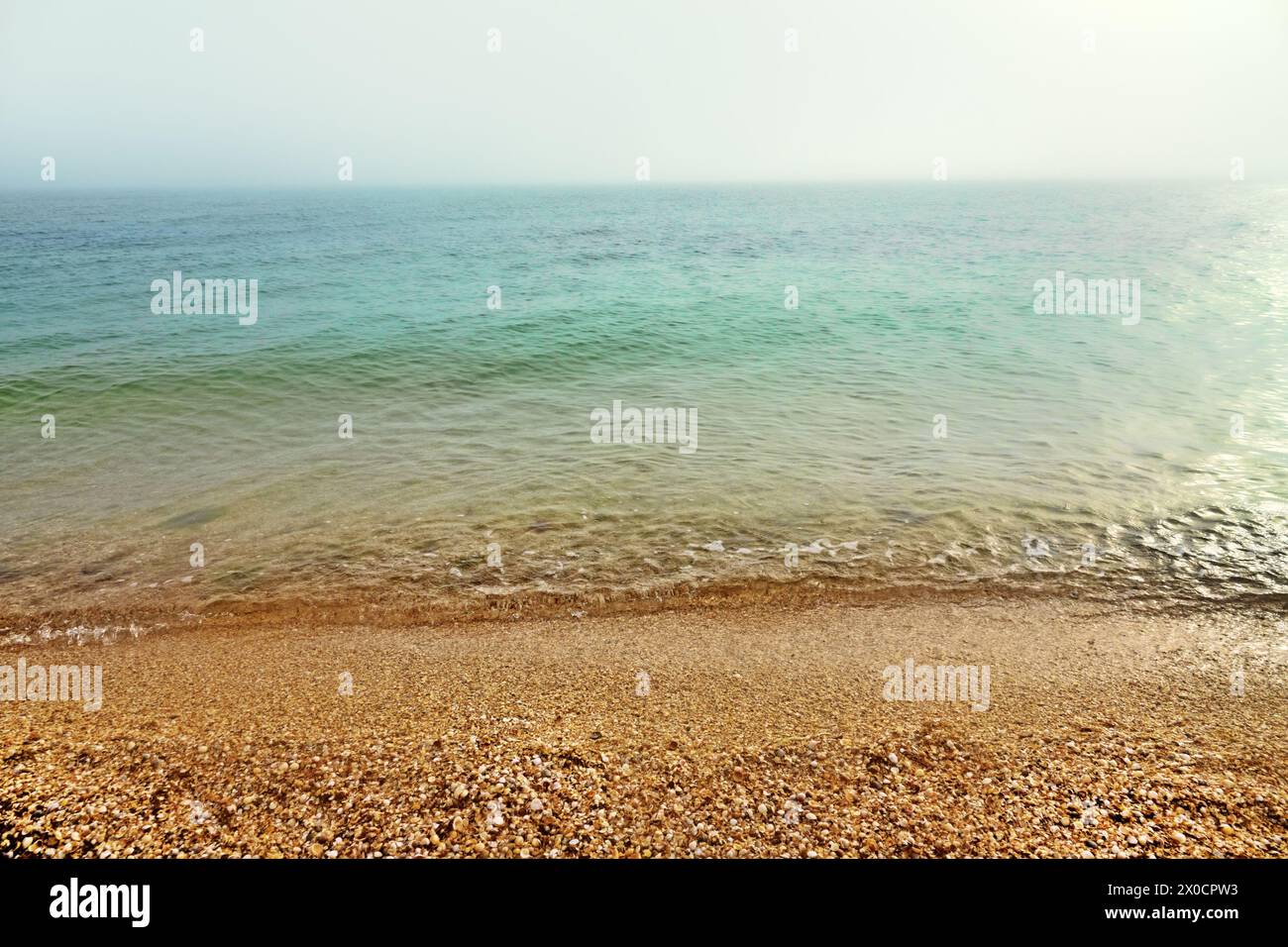 The Sea of Azov in the morning, at sunrise, the horizon in a haze Stock Photo