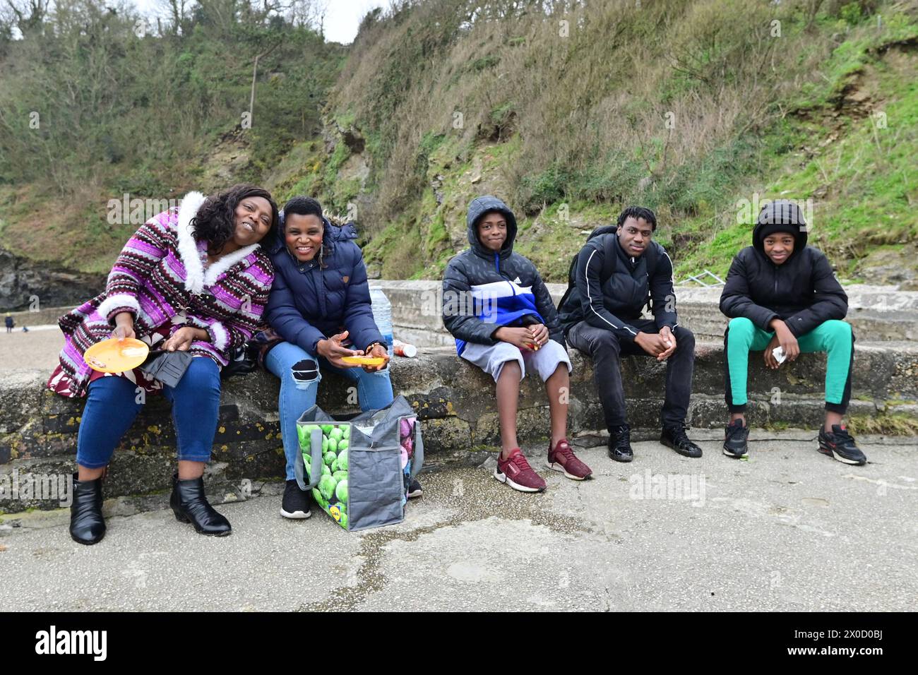 Cornwall, UK. 11th Apr, 2024. Visitors from London are seen enjoying lunch on the Harbour wall in Charlestown in Cornwall. Picture Credit: Robert Timoney/Alamy Live News Stock Photo