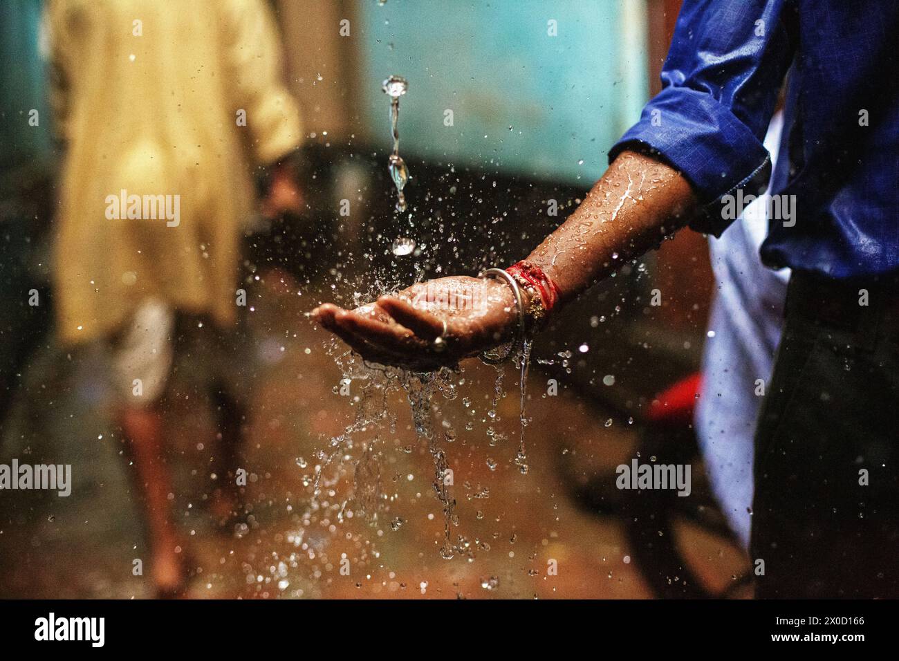 Man catching rain during monsoon season at Varanasi, India. Stock Photo