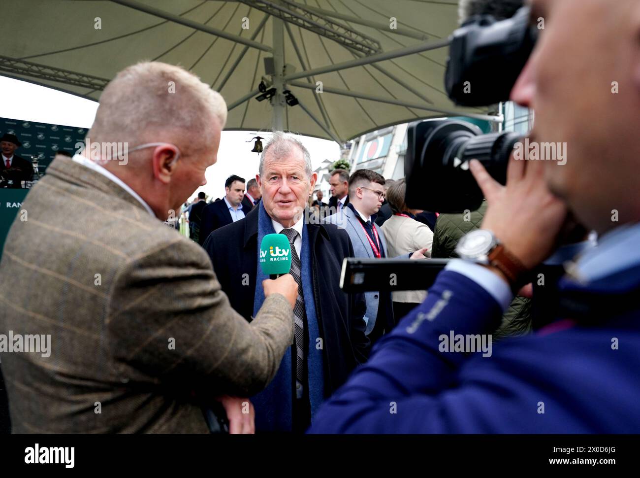 J.P. McManus is interviewed by ITV Racing after Its On The Line ridden by jockey Derek O'Connor (not pictured) wins the Randox Foxhunters' Open Hunters' Chase on day one of the 2024 Randox Grand National Festival at Aintree Racecourse, Liverpool. Picture date: Thursday April 11, 2024. Stock Photo