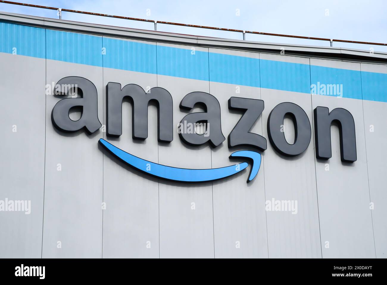 Bronx, NY - Oct 22, 2023: Amazon fulfilment center warehouse exterior with logo signage closeup in New York City Stock Photo