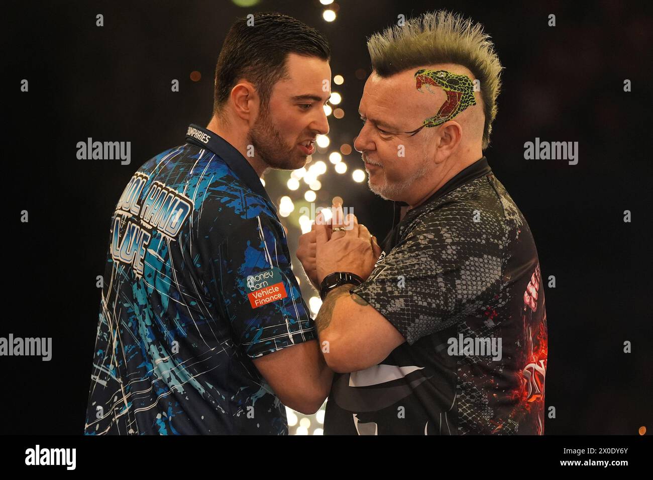 Luke Humphries (left) celebrates victory against Peter Wright at the end of their quarterfinal