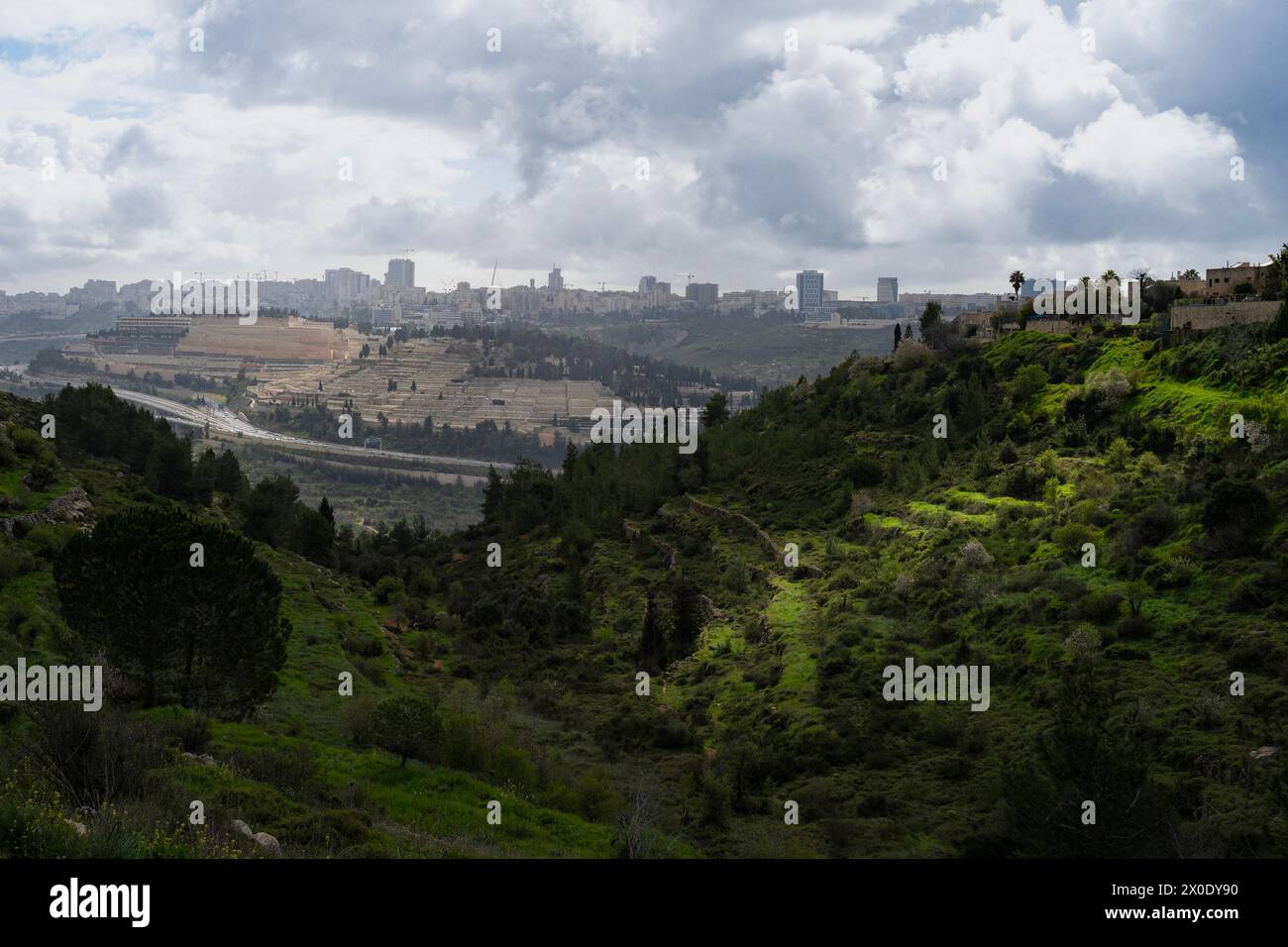 A landscape of northern Jerusalem, Israel, through the Halilim seasonal stream, as storm clouds gather above. Ancient agricultural terraces on the Jud Stock Photo