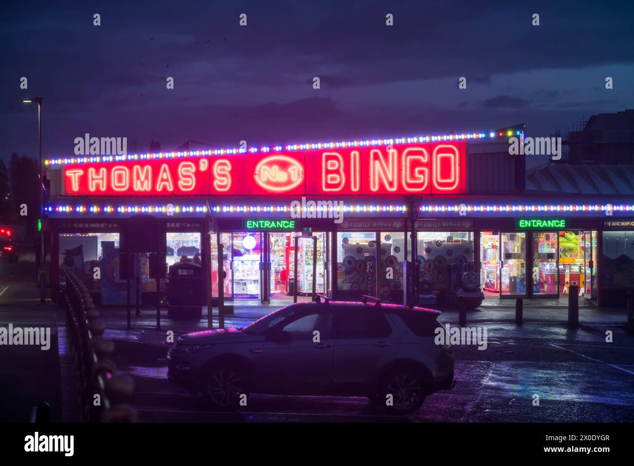 Neon sign on Thomas's Bingo hall, Hunstanton, on a stormy night. Stock Photo