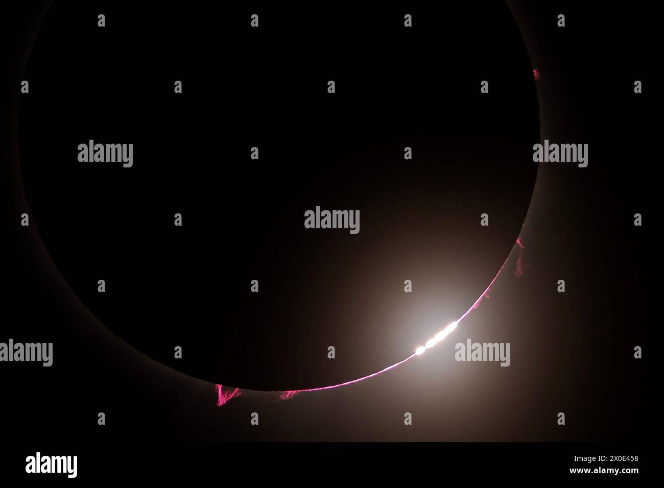 Solar flares and prominence are seen as the moon covers the sun during