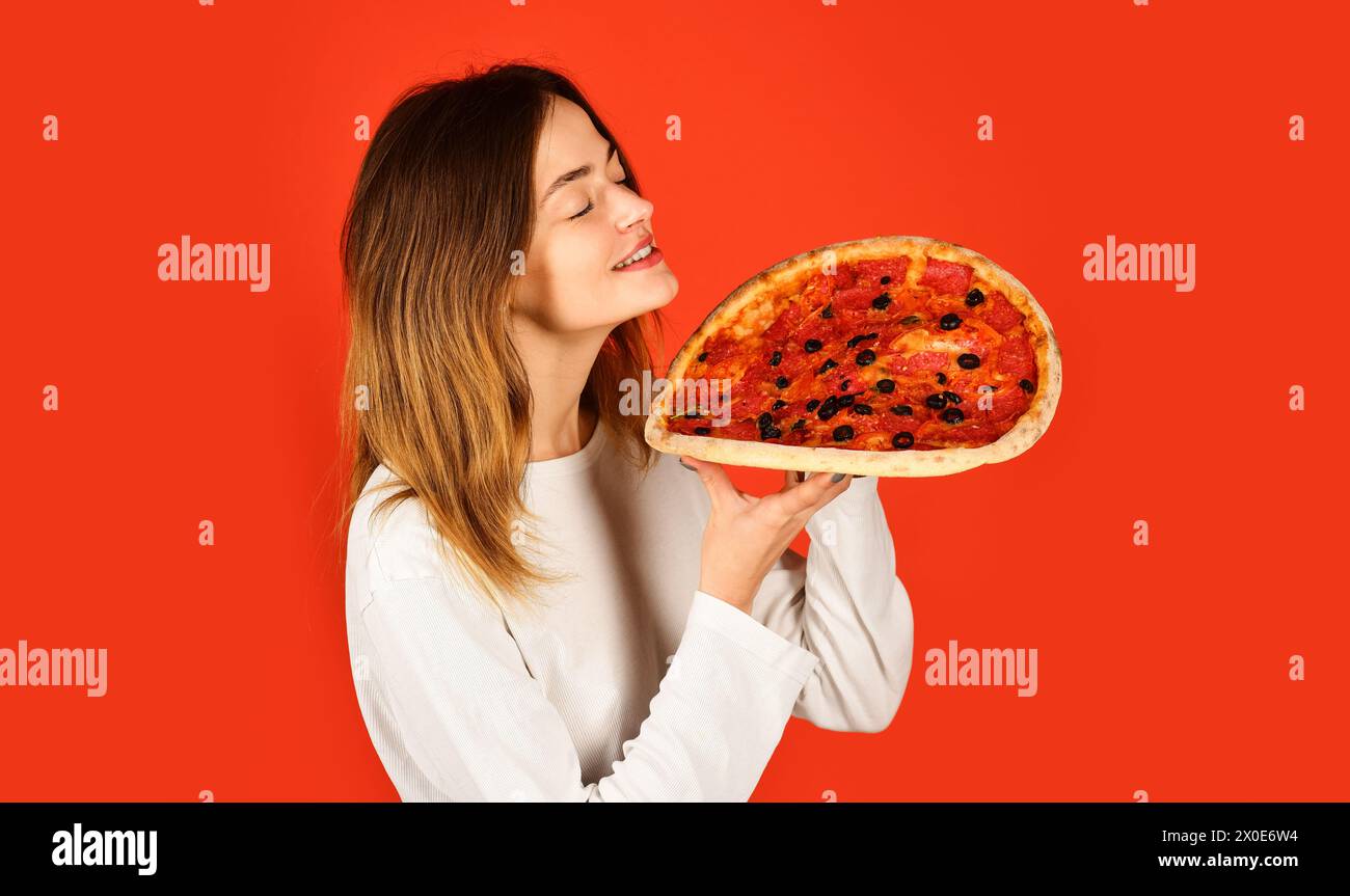 Pizza time. Satisfied girl with closed eyes with delicious pizza. Lunch or dinner. Beautiful woman in casual wear enjoy tasty pizza. Italian cuisine Stock Photo