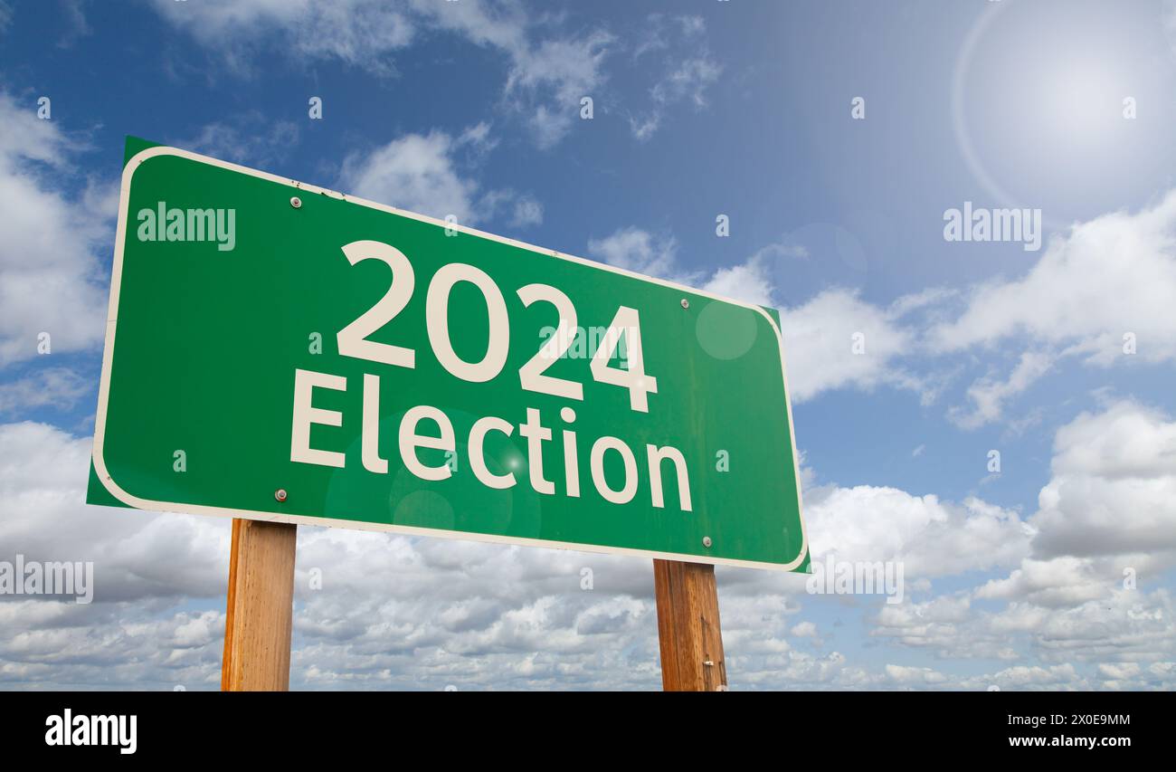 2024 Election Just Ahead Green Road Sign Over Clouds and Blue Sky. Stock Photo