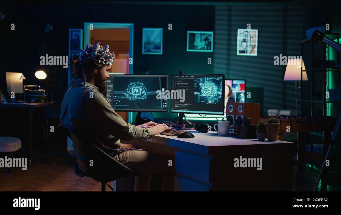 Man with EEG headset on writing code allowing him to transfer mind into ...