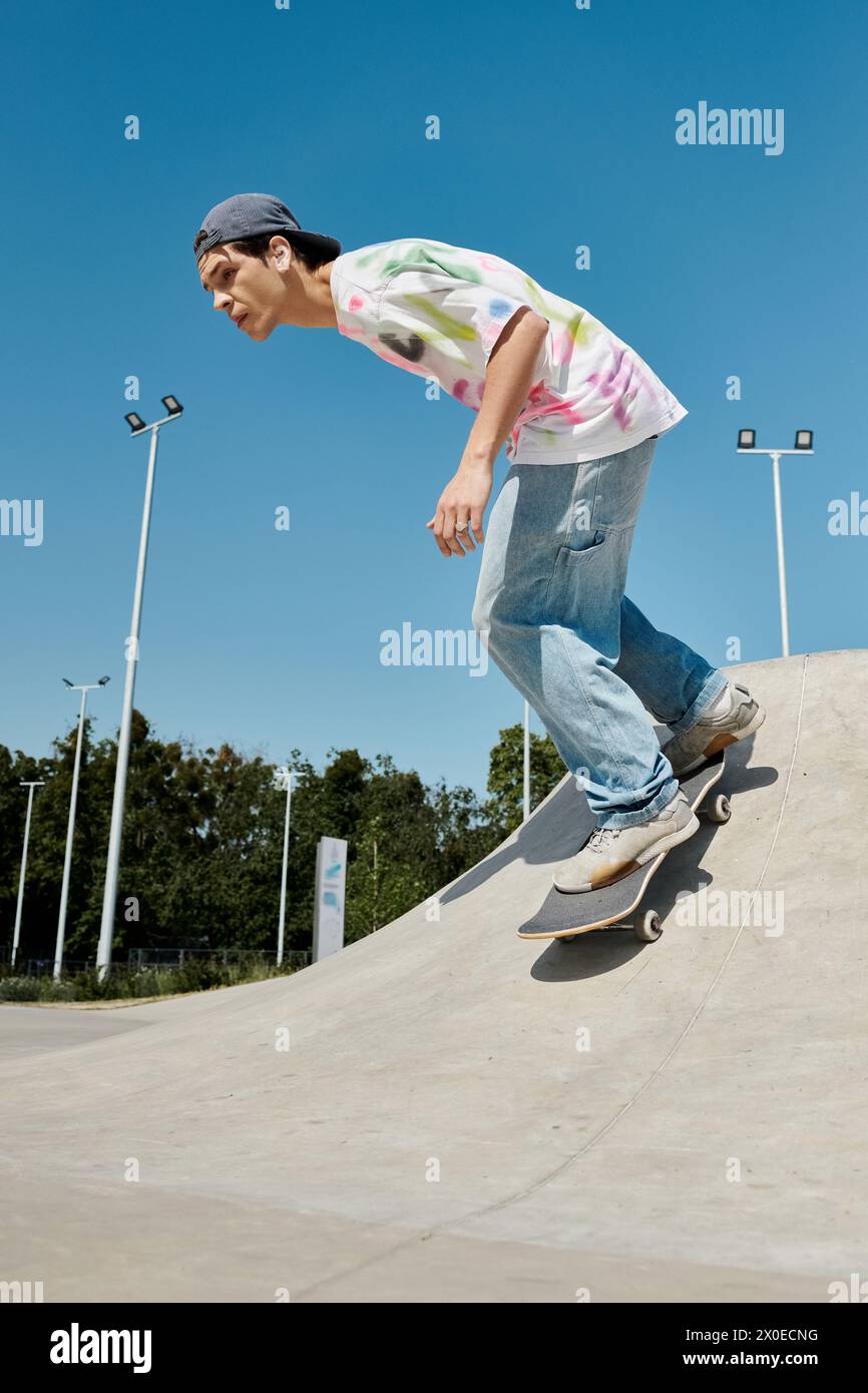 A young man glides effortlessly down the side of a ramp on his ...