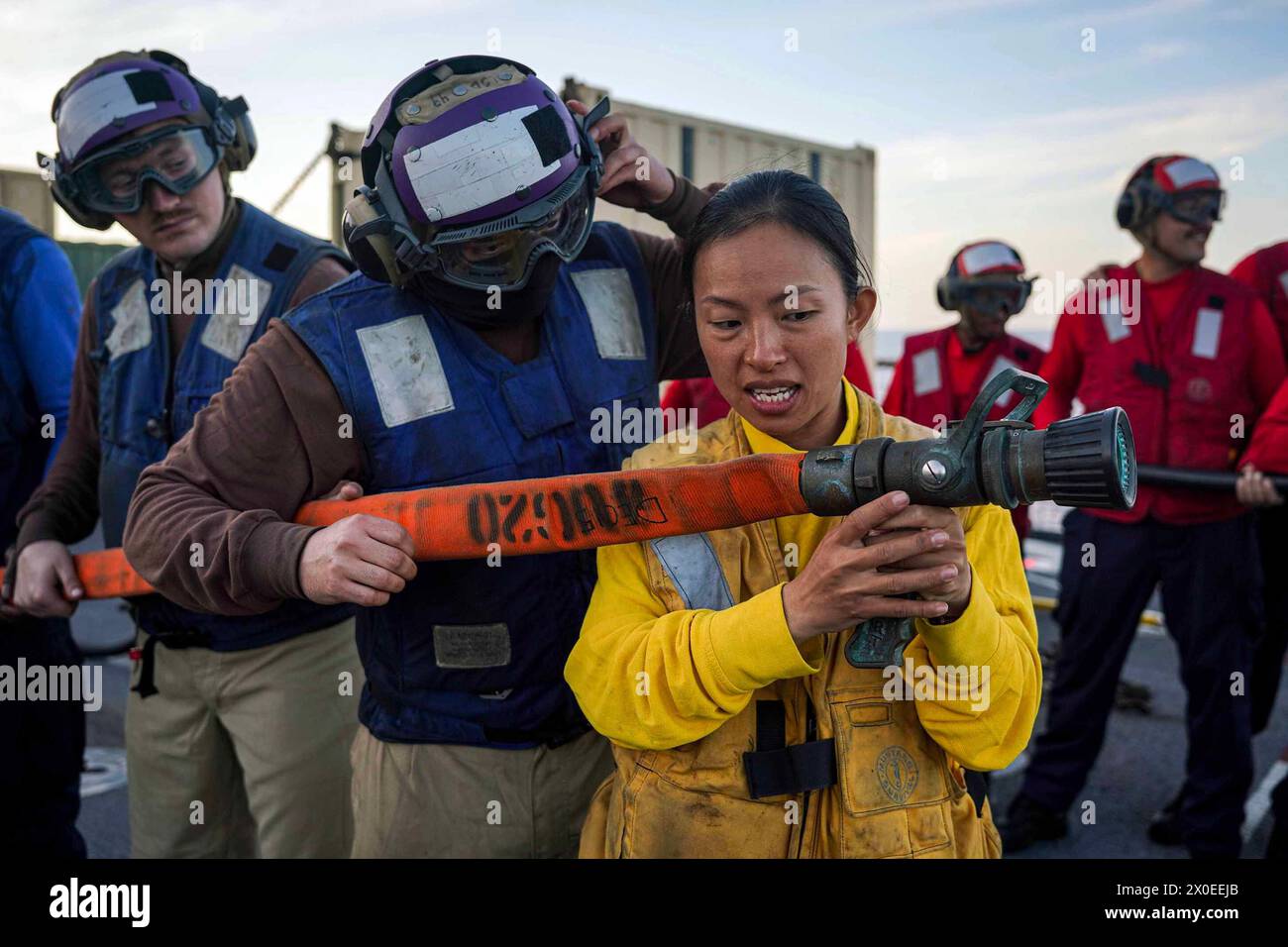 Pacific Ocean. 21st Mar, 2024. Boatswains Mate 2nd Class Yin Su, right, from Muse, Myanmar, instructs U.S. Marines, assigned to Alpha Company, 15th Marine Expeditionary Unit (MEU), how to man the nozzle of a firehose during an aircraft firefighting drill on the flight deck aboard the amphibious dock landing ship USS Harpers Ferry (LSD 49) while underway in the Pacific Ocean, March 21, 2024. Harpers Ferry is currently underway conducting routine operations in U.S. 3rd Fleet with elements of the 15th MEU. (photo by Sang Kim) (Credit Image: © U.S. Navy/ZUMA Press Wire) EDITORIAL USAGE ONLY! Not Stock Photo