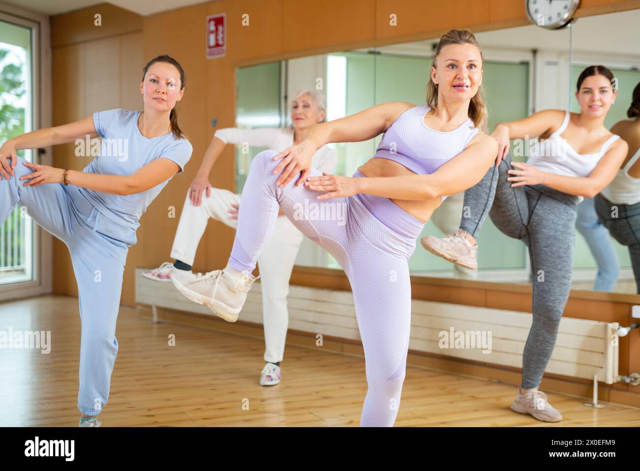 Group are practising arch movement in step jazz dance in fitness gym ...