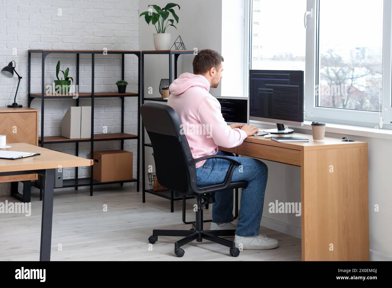 Focused male programmer working in office Stock Photo