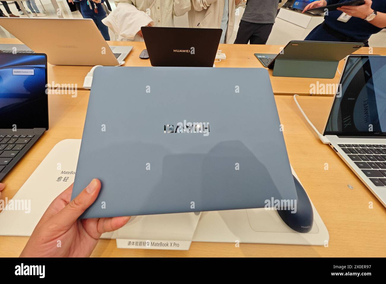 SHANGHAI, CHINA - APRIL  11, 2024 - Customers experience the MateBook X Pro, a newly released laptop from Huawei, at the Huawei flagship store on Nanj Stock Photo