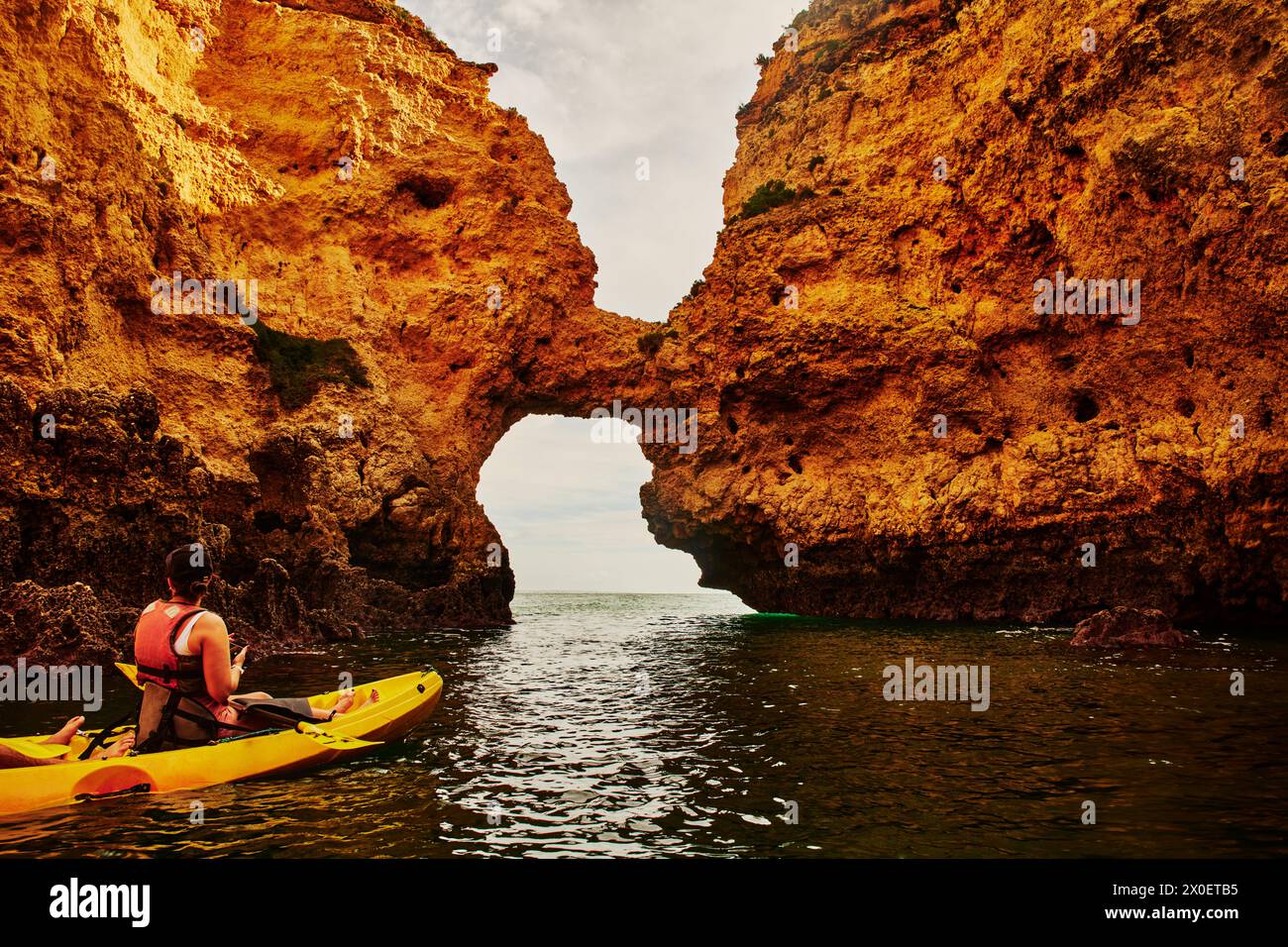 Kayaker exploring rock formations of Lagos, Portugal, Europe Stock Photo