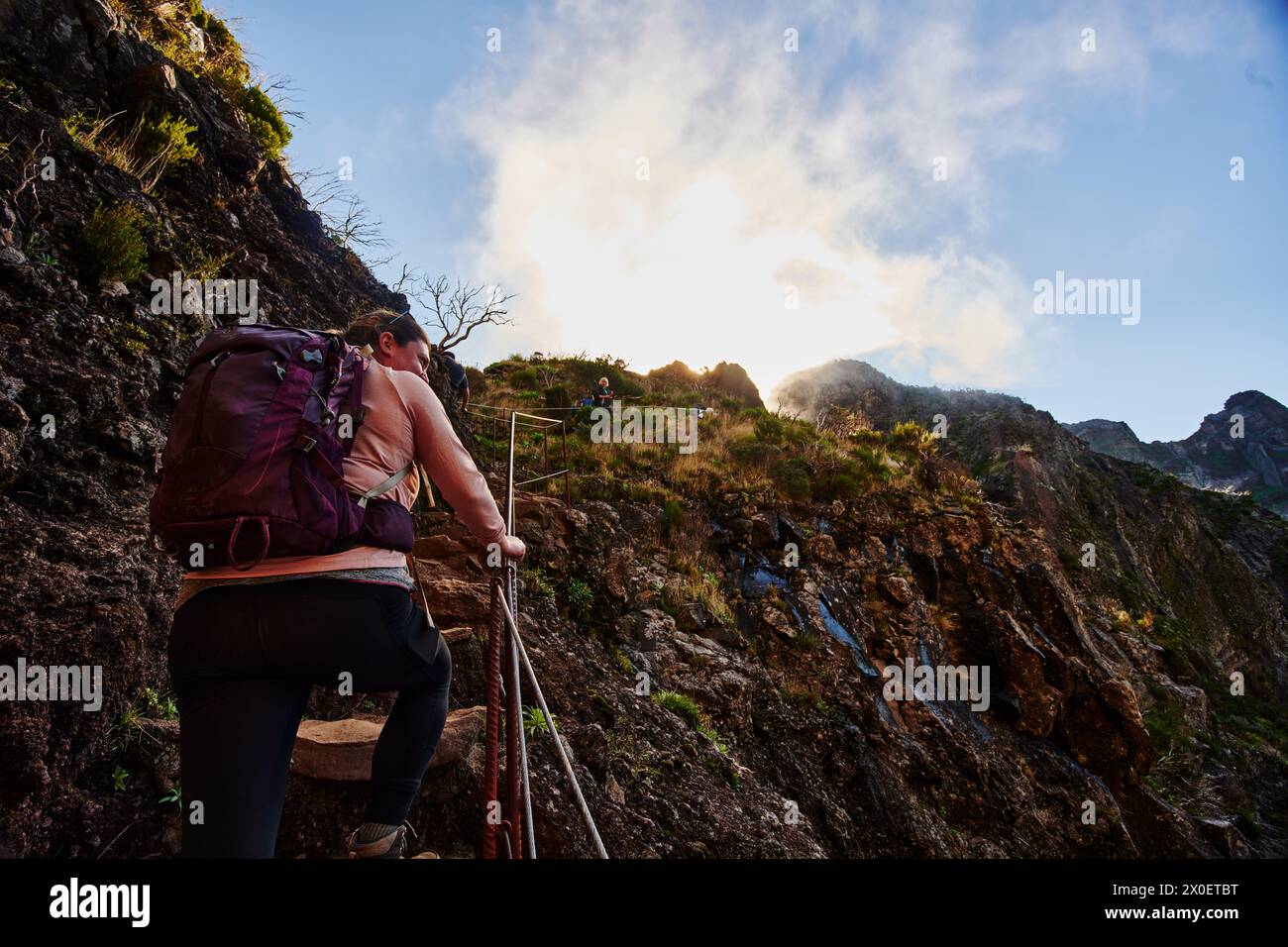 Female hiker enjoying PR1 trail,  Pico do Arierio To Pico Ruivo Hike, On Madeira Island, Portugal, Europe Stock Photo