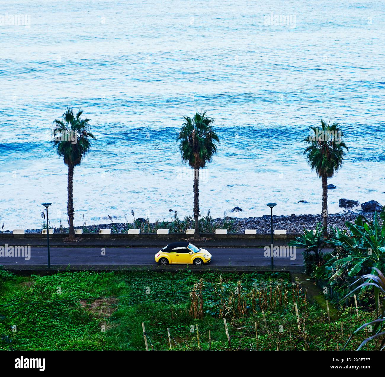 Classic car driving along the Porto Moniz coastline in Madeira, Portugal, Europe Stock Photo
