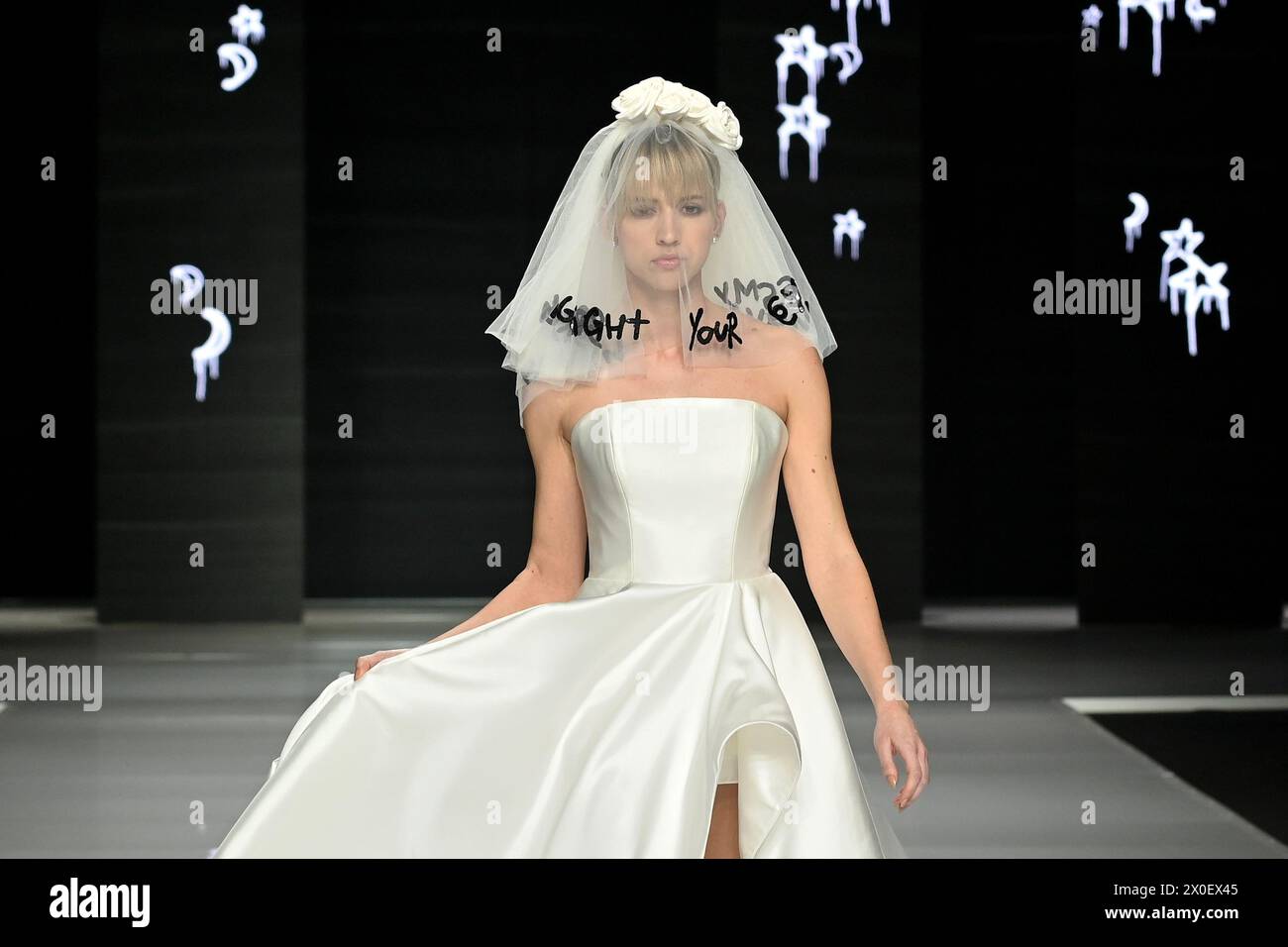 SI SPOSAITALIA Collezioni 2024, Brindal Week at Fieramilano City in Milan, Italy on April 5-8, 2024. Presentation of wedding dresses and ceremony. In the photo: Justin Alexander Signature fashion show with street artist Gioele Corradengo.  (Photo by Laura Villani/Sipa USA) Stock Photo