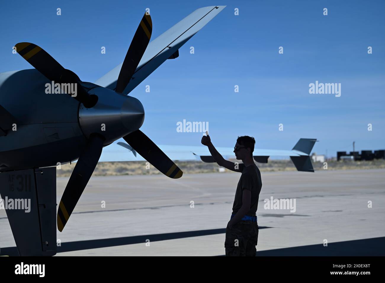 U.S. Air Force Airman 1st Class Kyle Phelps, 9th Aircraft Maintenance Unit maintainer, prepares an MQ-9 for taxi April 21, 2023. Holloman's use of the Reaper marks the first time an MQ-9 participated in a display of airpower. (U.S. Air Force photo by Airman 1st Class Michelle Ferrari) Stock Photo