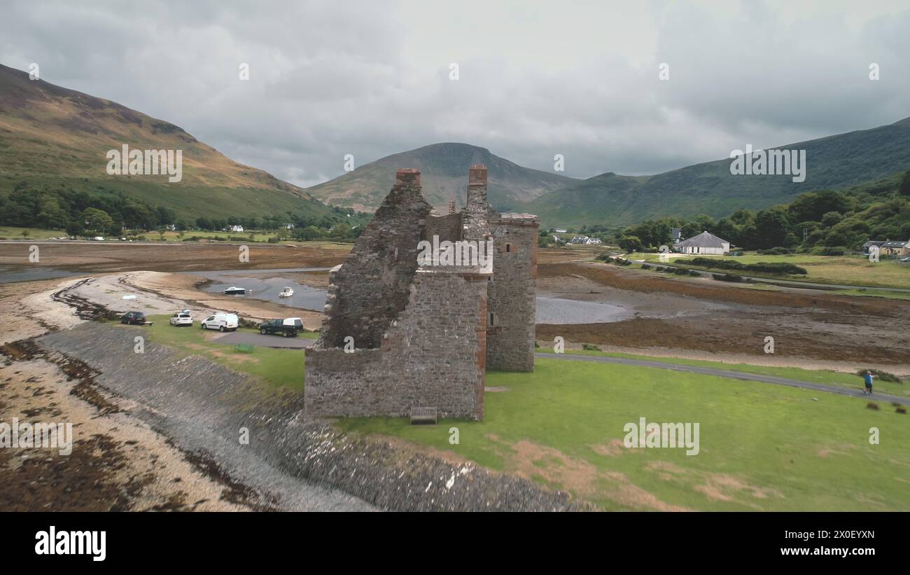 Closeup historical castle ruins aerial. Ruined architecture attraction at sea bay. Historic monument, heritage of culture. Ocean coast of Loch-Ranza, Arran Island, Scotland, United Kingdom, Europe Stock Photo