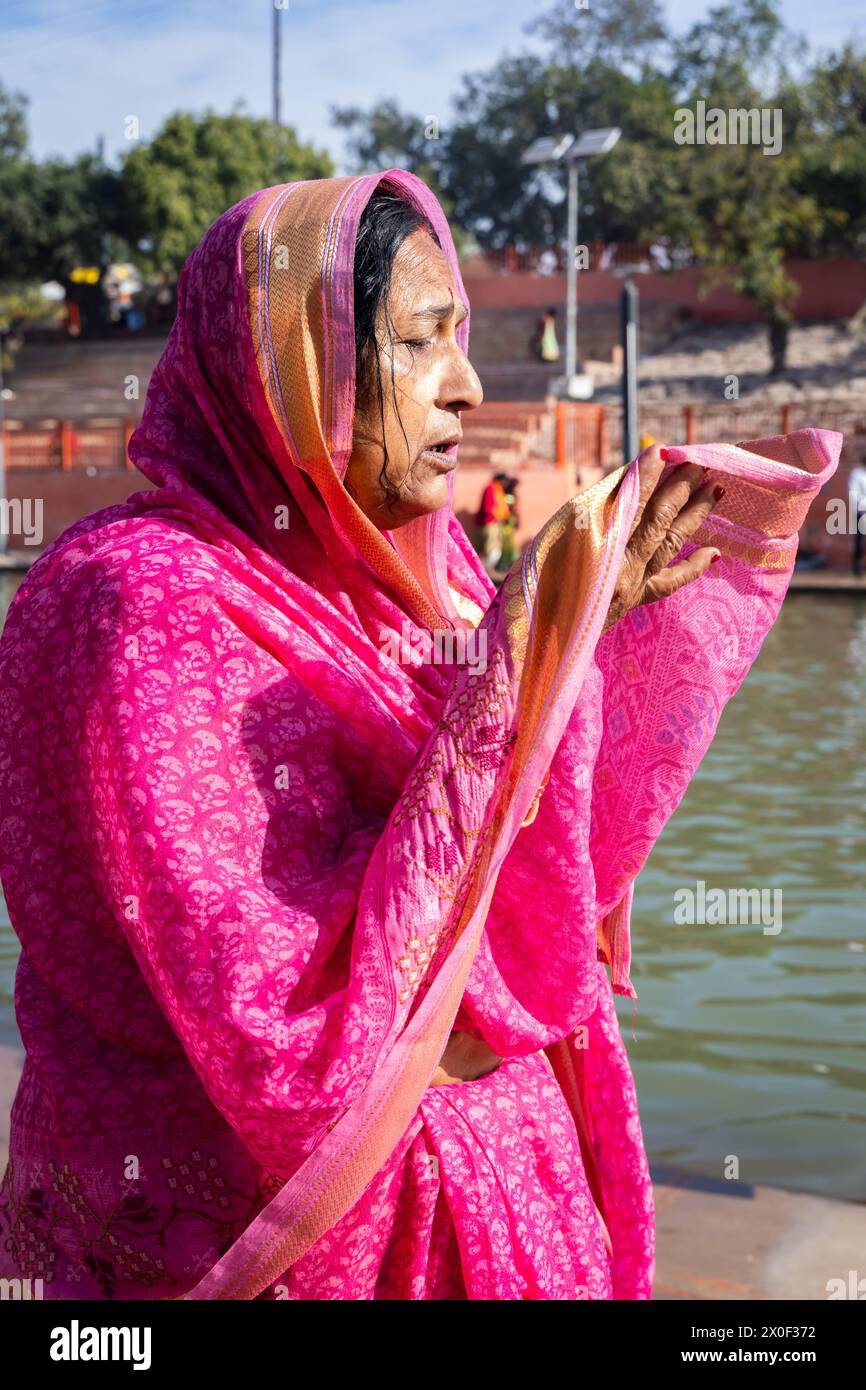 devotee praying for holy god after bathing in holy river water at ...