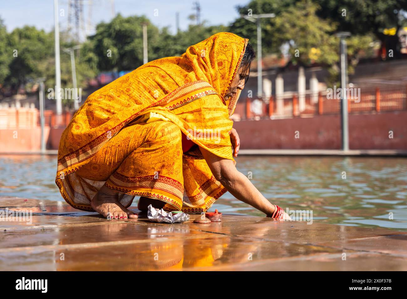 devotee praying for holy god after bathing in holy river water at morning from flat angle Stock Photo