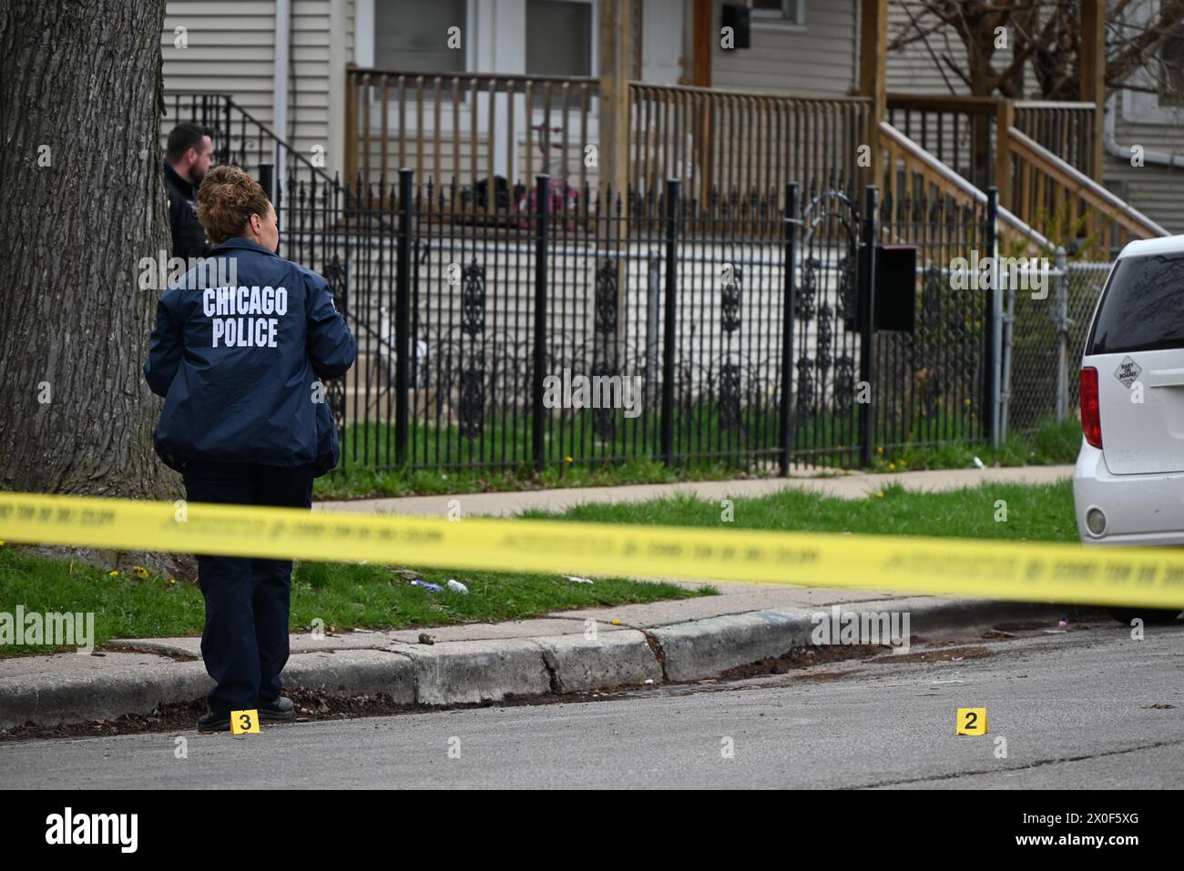 Chicago police officer takes photos of shell casings on the ground, a ...
