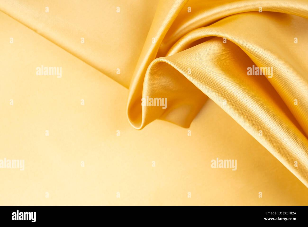 Golden Colored Fabric Textile, Abstract background. Stock Photo