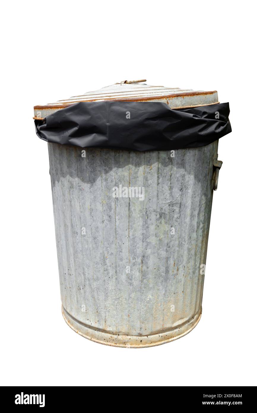 Rusty old trash with black plastic bag can isolated on white with a ...