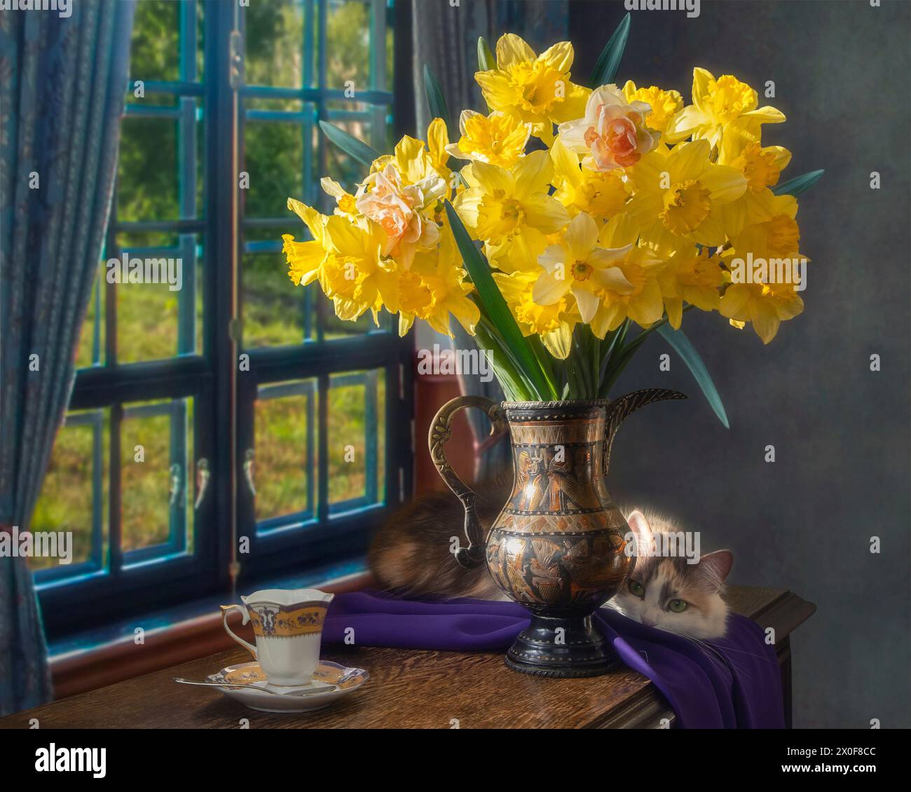 Still life with yellow daffodils and lovely cat Stock Photo - Alamy