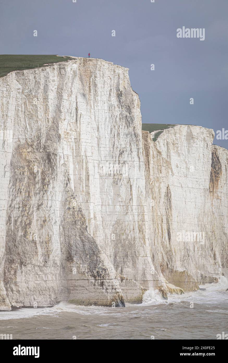 Standing on the cliff edge Cuckmere Brow of the Seven Sisters cliffs east Sussex south east England UK Stock Photo