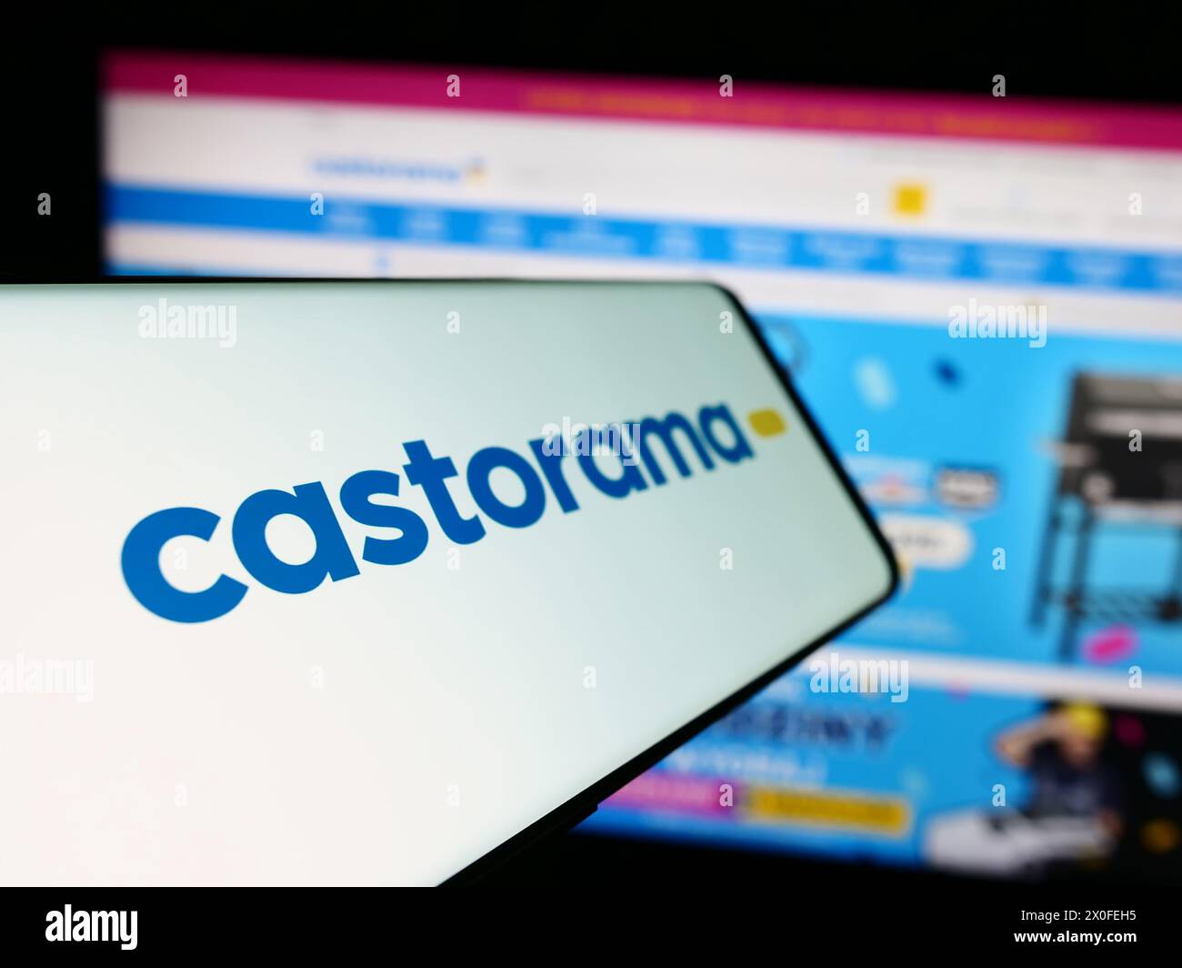 Cellphone with logo of home improvement store chain company Castorama in front of business website. Focus on left of phone display. Stock Photo