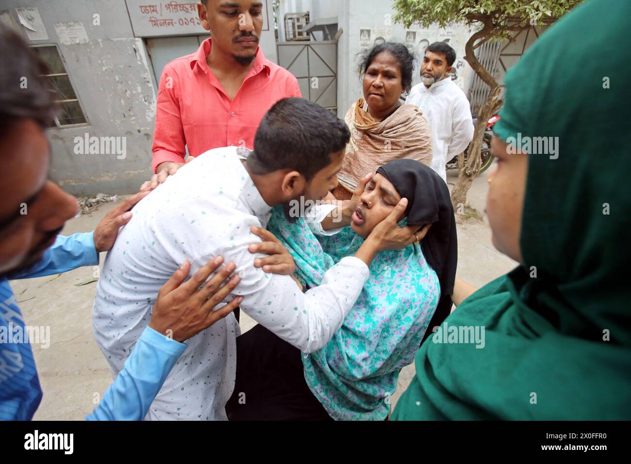 Dhaka, Bangladesh. 11th Apr, 2024. A relative reacts after seeing the ...