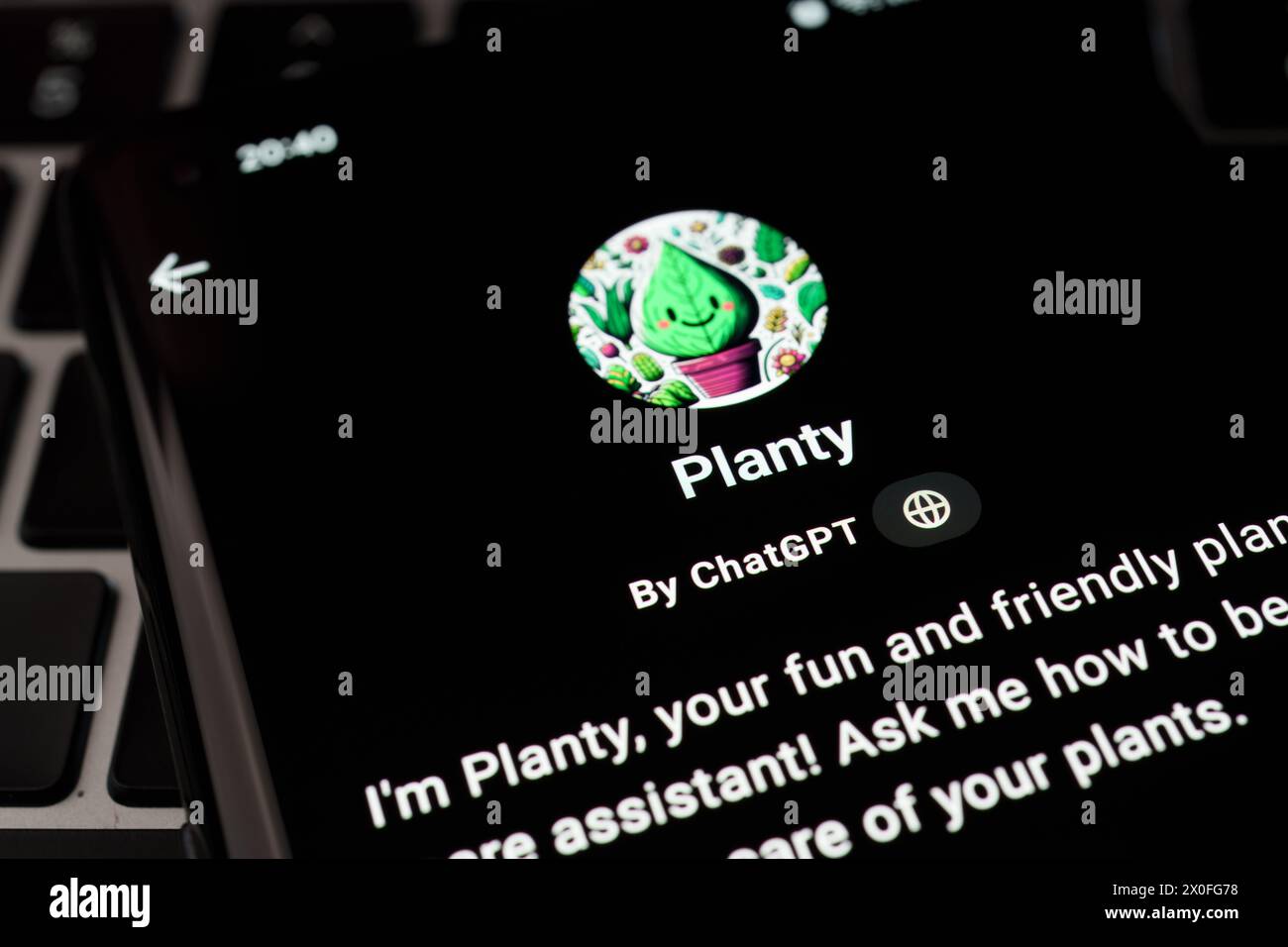 PLANTY custom GPT seen in GPT Store on the screen of smartphone placed on laptop keyboad. Stafford, United Kingdom, April 8, 2024 Stock Photo