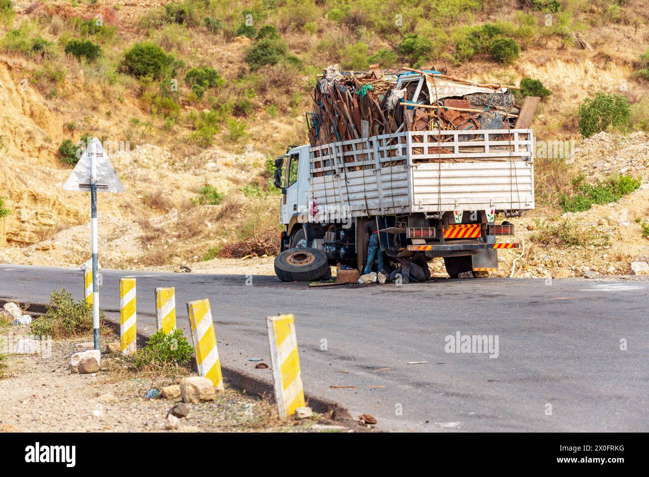Damaged old truck by the road. A trucks wheel fell off. A common view of transportation in Ethiopia. Oromia Region. Ethiopia Stock Photo