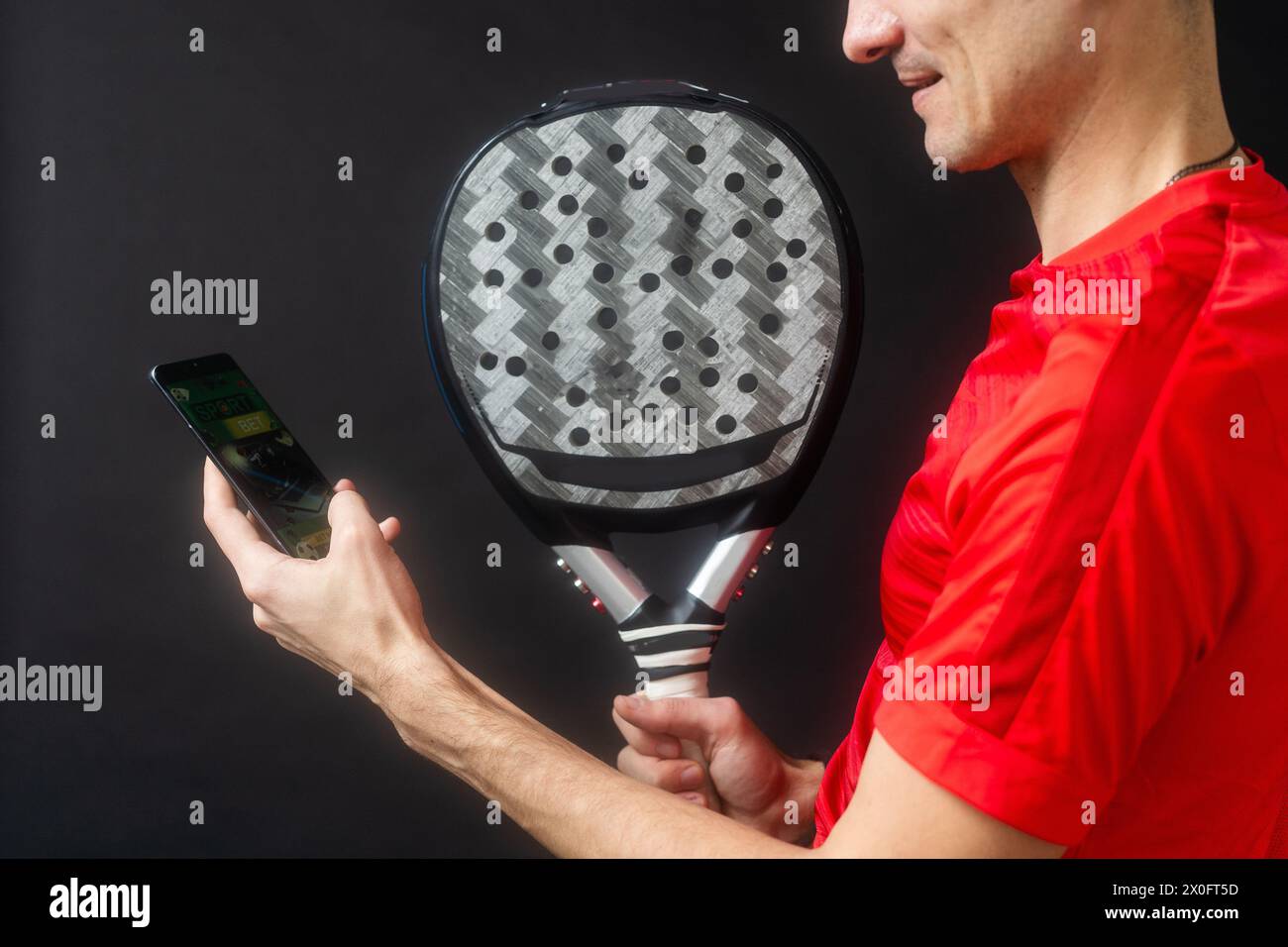 Smart Racket With Phone man holding paddel racket and smartphone Stock Photo - Alamy
