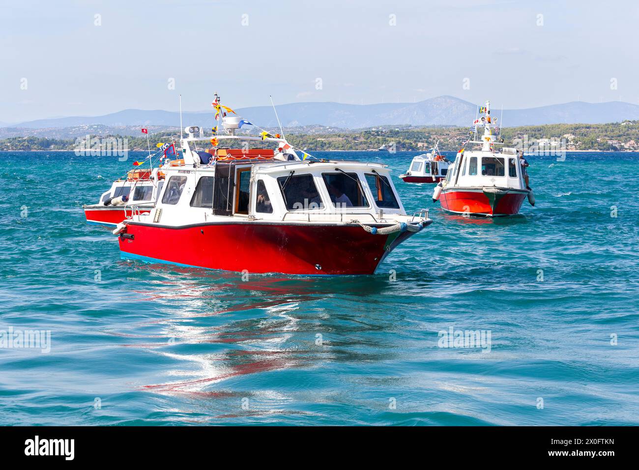 Sea taxis at the small port of Dapia, in Spetses island, Greece, on the day of the Armata, the most popular local festival. Stock Photo