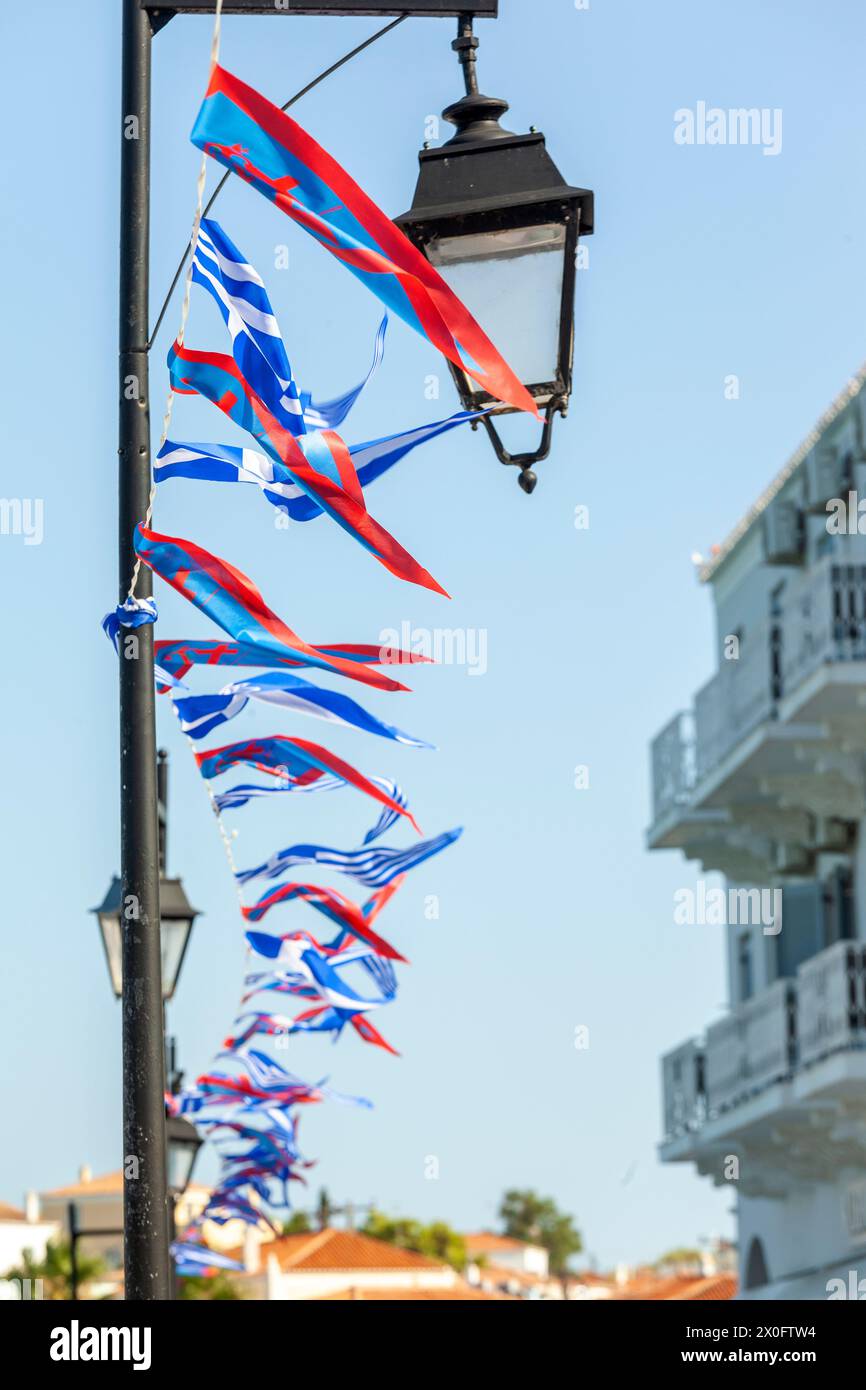 Local flags and ensign in Spetses island during the festivities for the most popular local festival, the Armata. Stock Photo