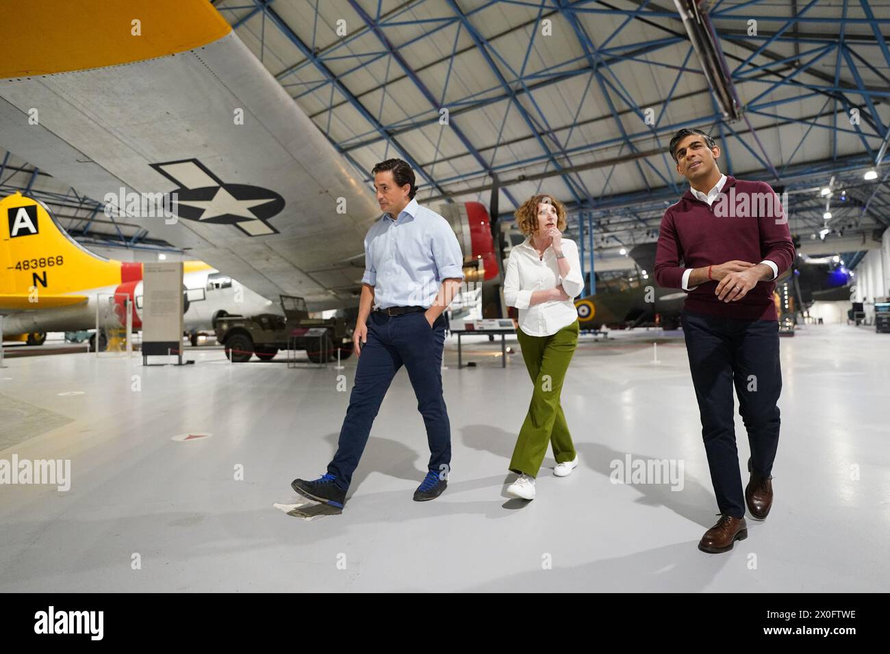 Prime Minister Rishi Sunak and Minister for Veterans' Affairs Johnny Mercer (left) walk with Maggie Appleton, the CEO of the RAF Museum services, ahead of a Q&A event in north west London, as he launches an employment plan which pledges to help veterans secure high-paid jobs after they leave the armed forces. Picture date: Friday April 12, 2024. Stock Photo