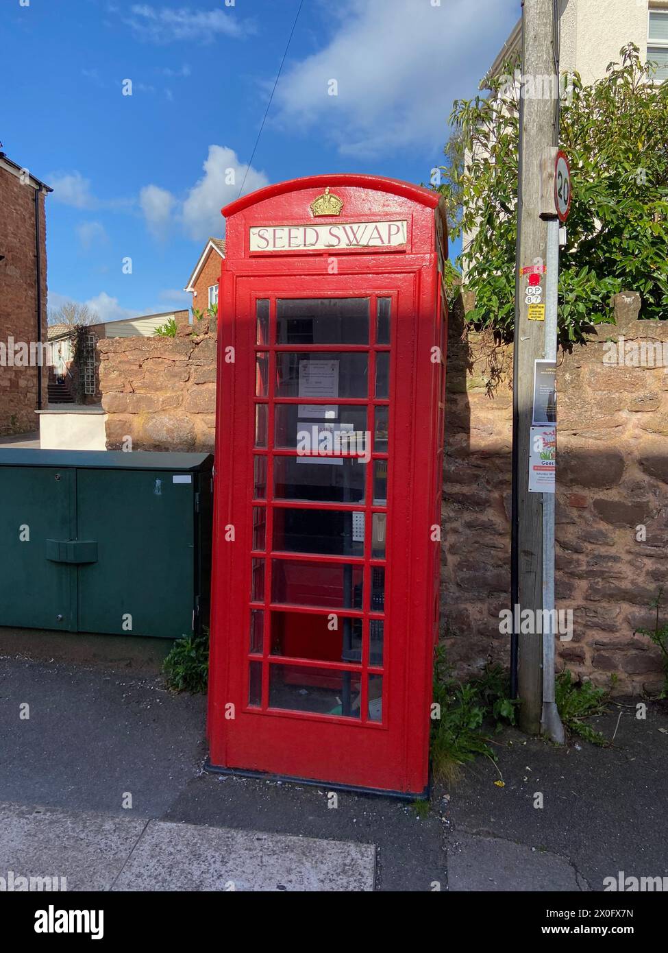 a classic K2 british red telephone kiosk being reused as a seed swap in bishops lydeard near taunton somerset england UK Stock Photo