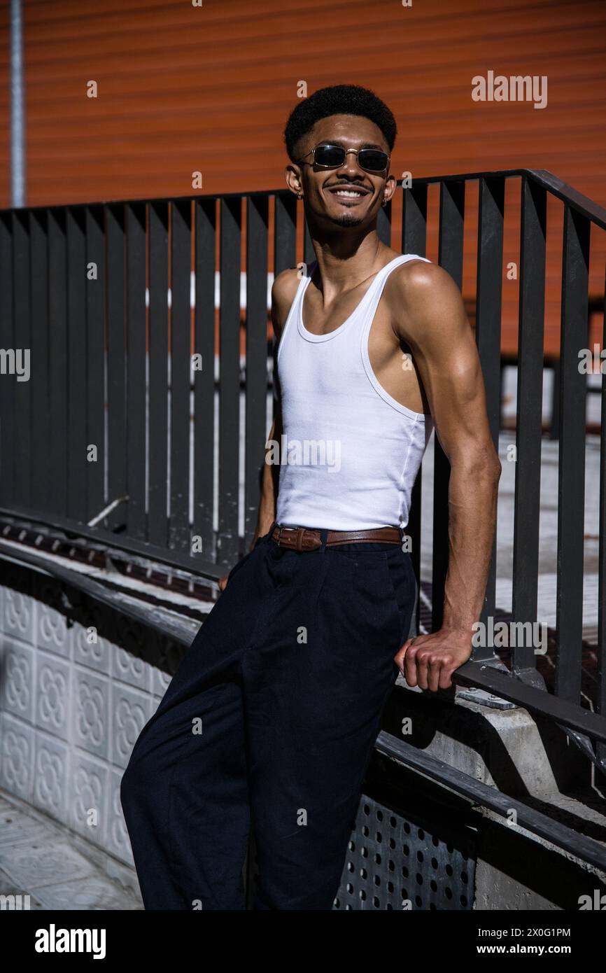 Satisfied successful male leaning against a handrail. Stock Photo