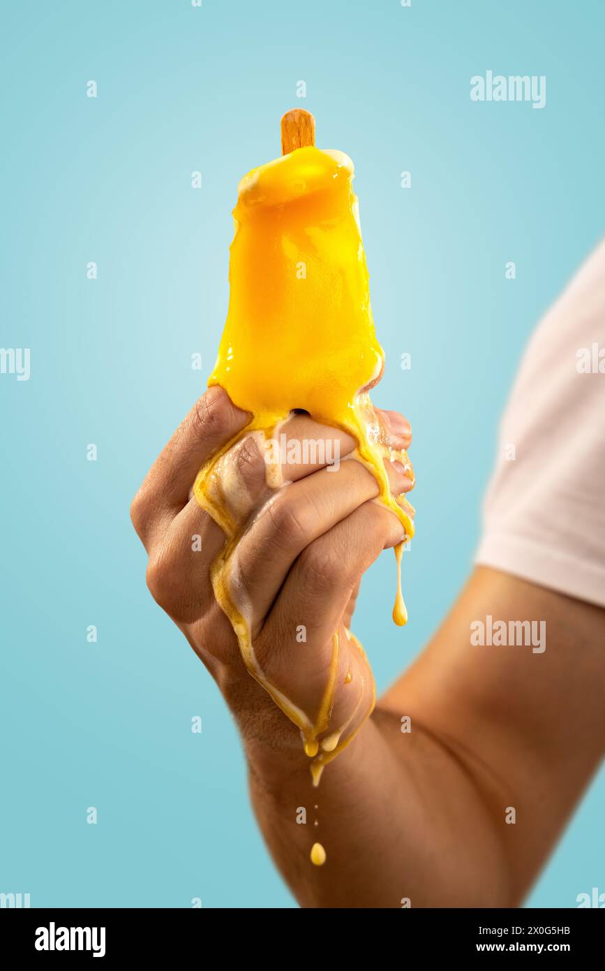 Melting Ice Pop Held by a Hand Stock Photo