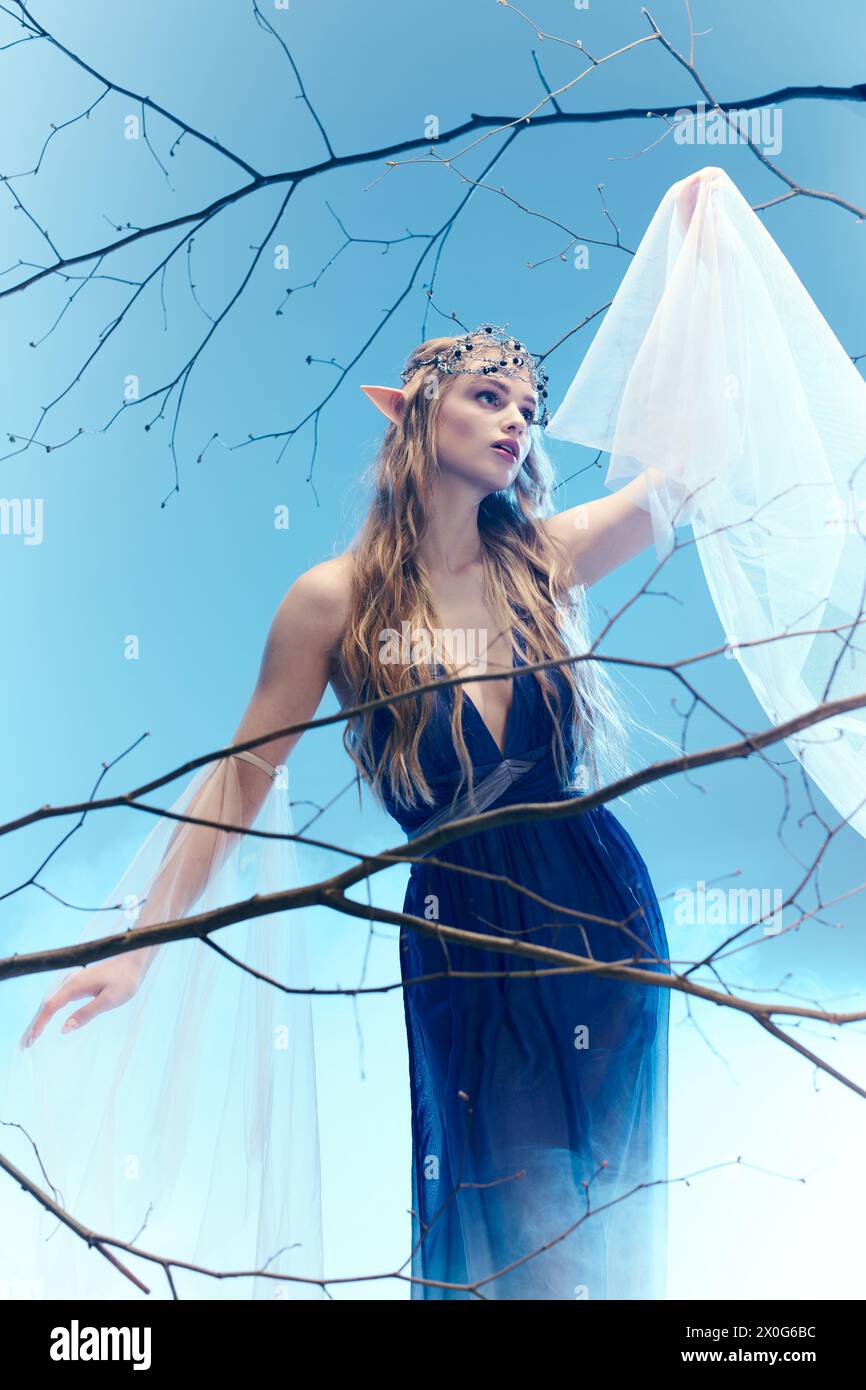 A young woman in a flowing blue dress, resembling an elf princess ...